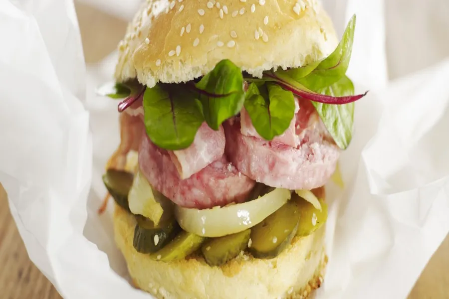 Burger brioché de saucisson chaud, oignons confits