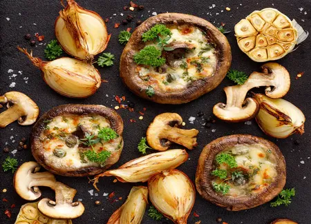 Champignons farcis lentilles, quinoa, au camembert coeur de lion et oignons rôtis aux herbes
